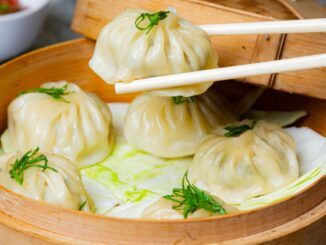 Steamed momos filled with meat and vegetables, served with spicy dipping sauce.