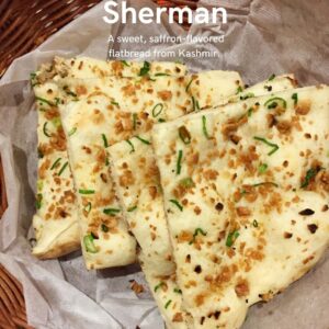 Sheermal, a saffron-infused sweet flatbread from Kashmir, served with aromatic meat dishes like Rogan Josh
