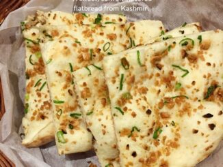 Sheermal, a saffron-infused sweet flatbread from Kashmir, served with aromatic meat dishes like Rogan Josh