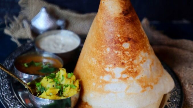 Dosa: A Savory South Indian Pancake Delicious crispy dosa served with coconut chutney and sambar